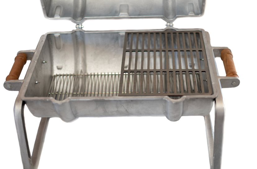 A small aluminum portable grill with a hinged lid, metal grate, and brown handles, shown against a white background with black letterboxing above and below.