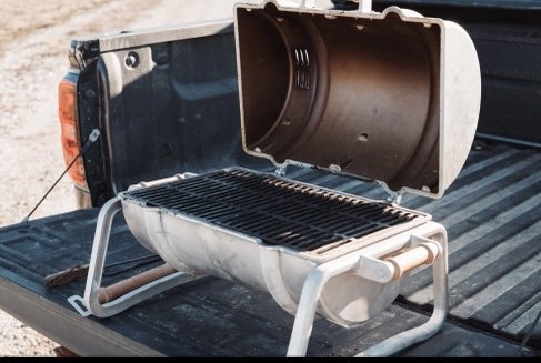 Grill grate and accessories on an open tailgate