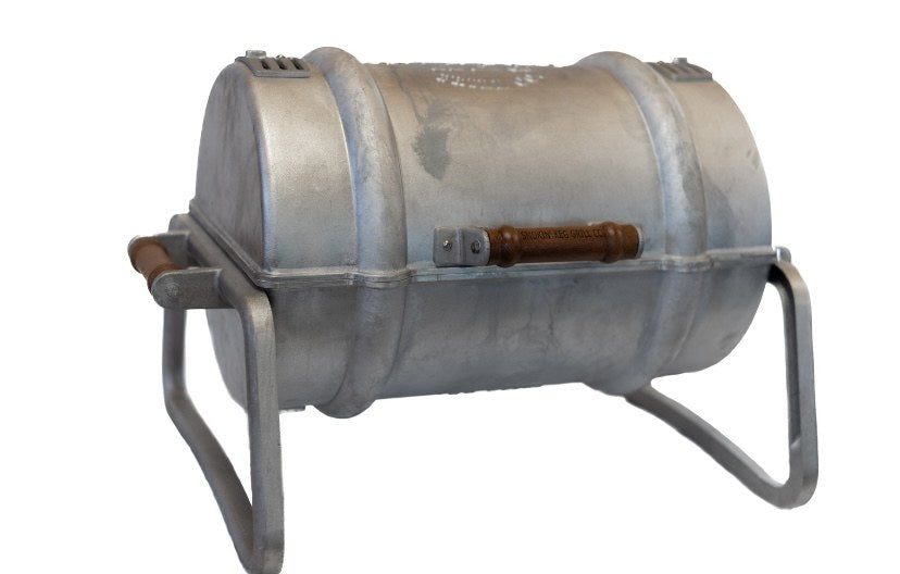The Smokin' Keg grill, cast aluminum body on a folding stand