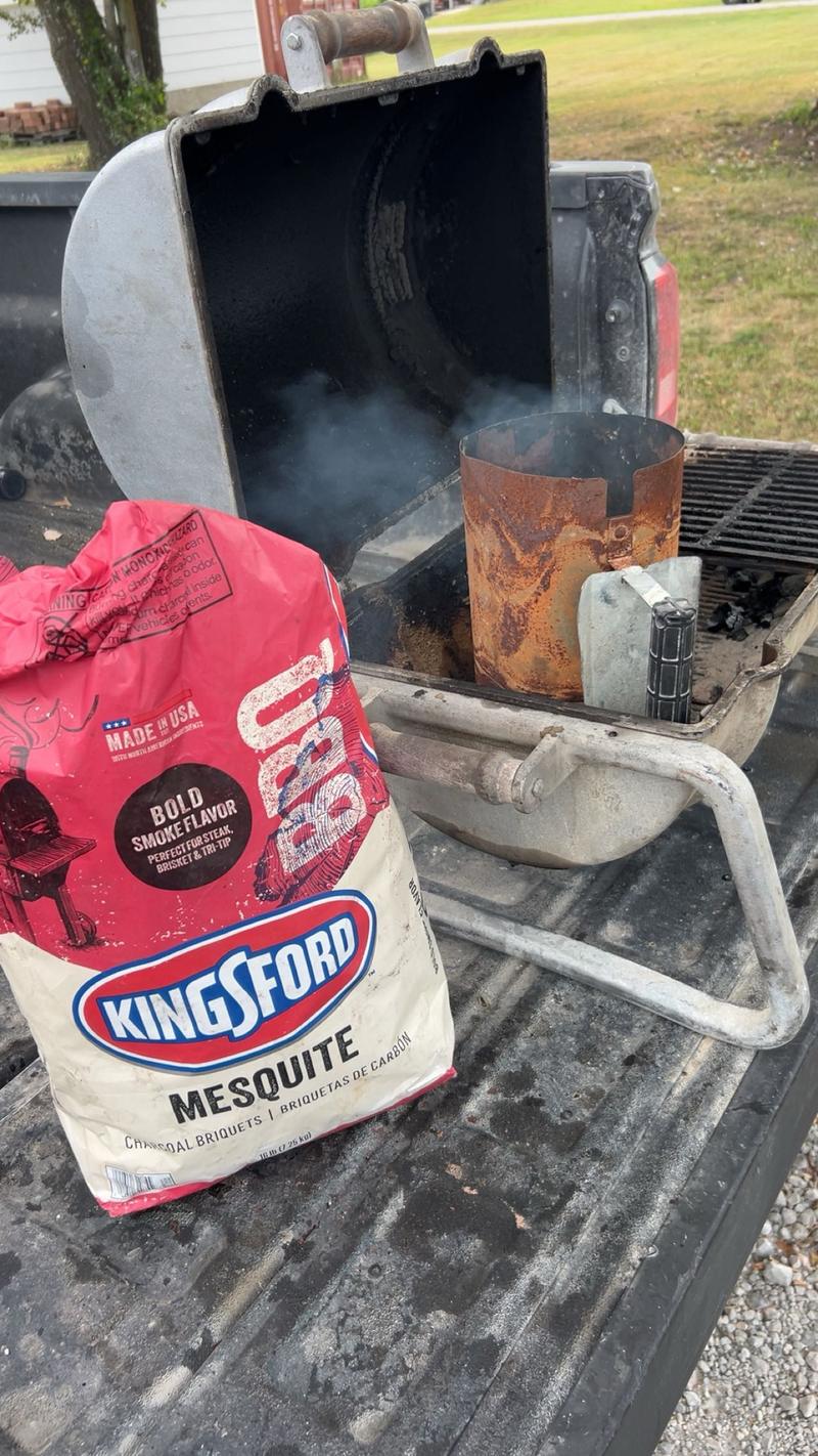 Charcoal chimney starter loaded in the grill