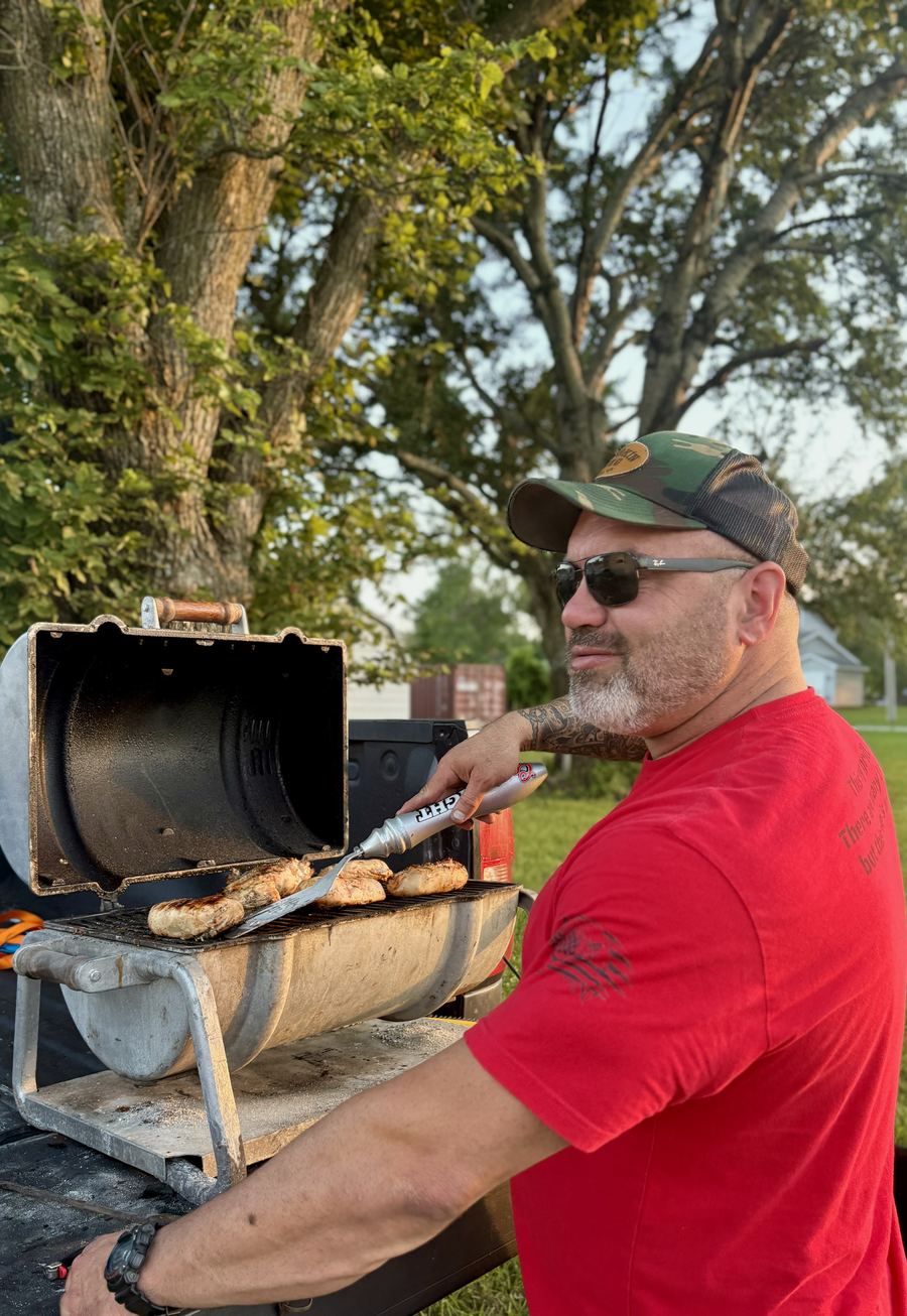 A Smokin' Keg grill set up and cooking outdoors